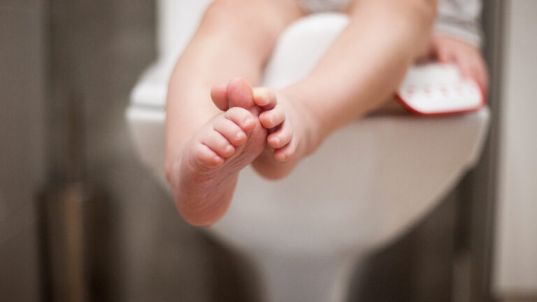 Baby sitzt auf der Toilette